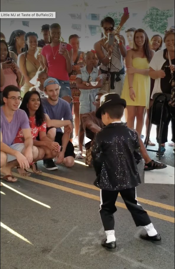 Caleb Brewer performing a Michael Jackson tribute routine in front of a crowd at Taste of Buffalo